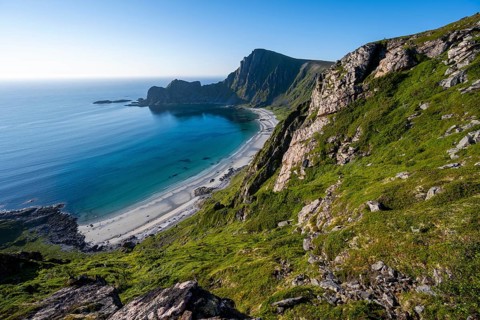 View of coastal landscape, cliffs with peak Måtind or Måtinden, Høyvika beach and sea, hike to the