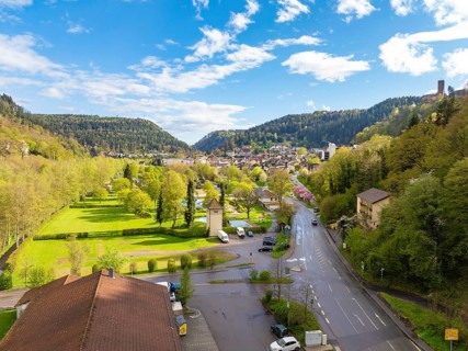 View of town with neighbouring forest and hills under blue sky, Bad Liebenzell, district Calw,