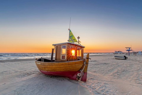Traditional wooden fishing boat on the beach along the Baltic Sea at Ahlbeck, Heringsdorf on the