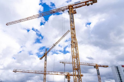 Construction cranes, on a large construction site in Düsseldorf, construction of condominium in the