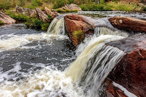 Rocks and vegetation in the river in the Biribiri mountain range in Diamantina, Minas Gerais,