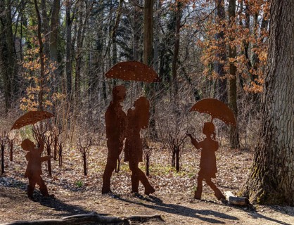 Rusty figures with umbrella, art installation on the grounds of the former tuberculosis sanatorium