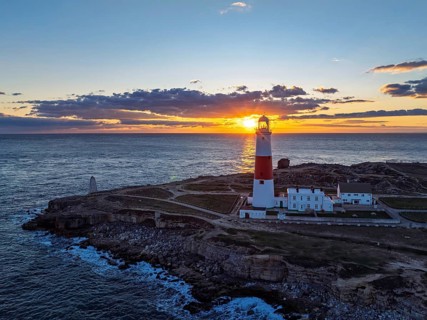 Sunset over Portland Bill Lighthouse from a drone, Portland Bill, Isle of Portland, Dorset,