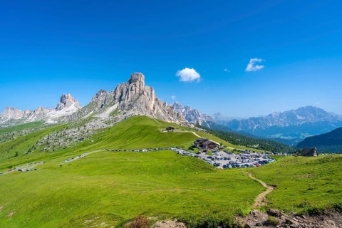 Panoramic view of the parking area at passo giau in the dolomites on a sunny summer day,