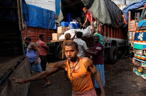 GUWAHATI, INDIA - MAY 1: Labourers carries goods in a wholesale market, in Guwahati, India, on May