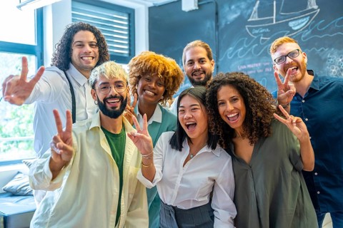 Portrait of a team of young and multiracial cowokers gesturing success