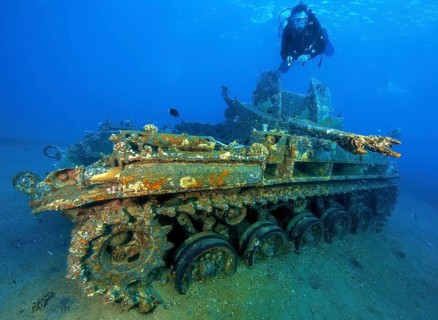 Underwater photo of diver swimming above looking at as an attraction for underwater sportsmen