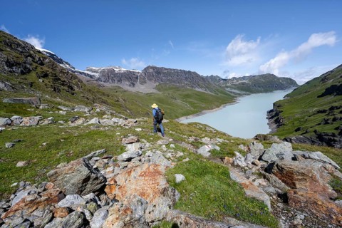 Mountaineer on hiking trail in front of Lac des Dix reservoir, Valais Alps, Valais, Switzerland,