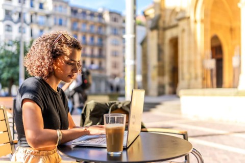Horizontal photo with copy space of a Young arab entrepreneur working with laptop in sidewalk