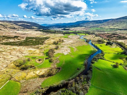 Farms and Mountains over River Dochart and Road A85 from a drone, Perthshire, Scotland, UK