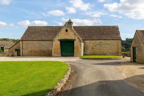 Historic nineteenth century farmyard stone barn building, Yanworth, Gloucestershire, England, UK