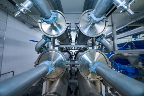 View of an industrial pipe system with many metal elements and blue coatings, ENCW Netze Calw