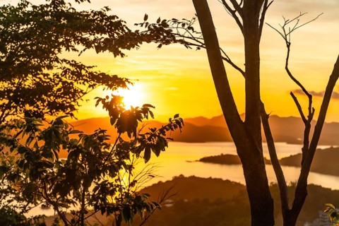 Majestic golden sunset illuminating the tranquil waters and lush islands surrounding coron,