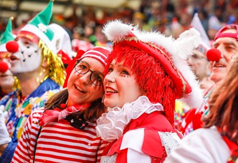 Colourfully costumed carnivalists celebrate carnival in Cologne, on Weiberfastnacht the street