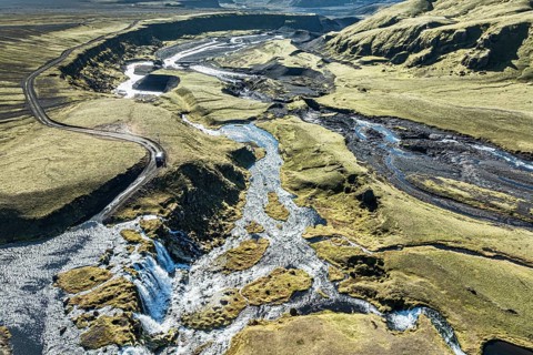 Road F232 Öldufellsleid, along northern slopes of glacier Myrdalsjökull, moss-covered hills in