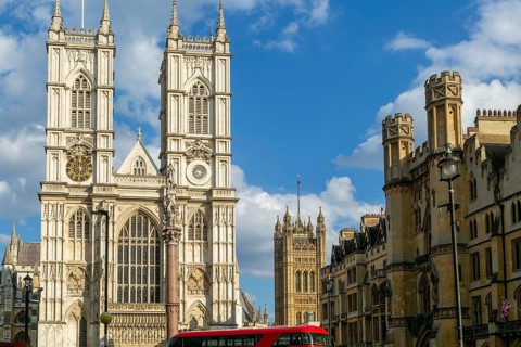Towers and frontage of Westminster abbey church with Victoria Tower in background, Westminster,