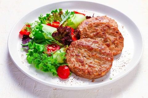 Fried cutlets, turkey, with vegetable salad, top view, no people
