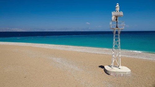Northern tip of Rhodes, isolated lighthouse on sandy beach with wide sea view, harbour area, Rhodes