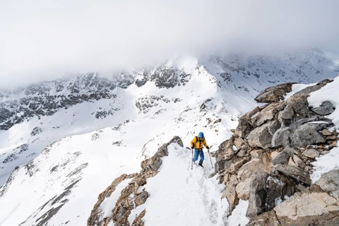 Mountaineers climbing the ridge of Piz Laviner, view of wintry mountain landscape, Grisons Haute