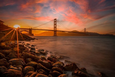 Gorgeous orange sunset with pink clouds over the Golden Gate in San Francisco, California. United