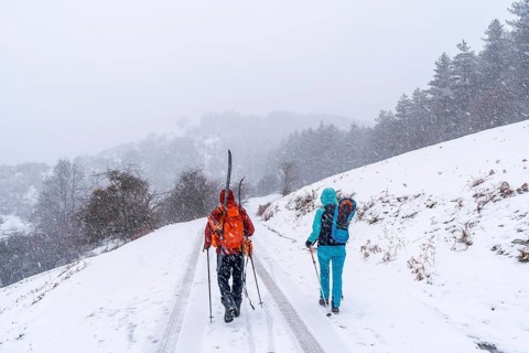 A couple of skiers on Mount Aizkorri in Gipuzkoa. Snowy landscape by winter snows. Basque Country,