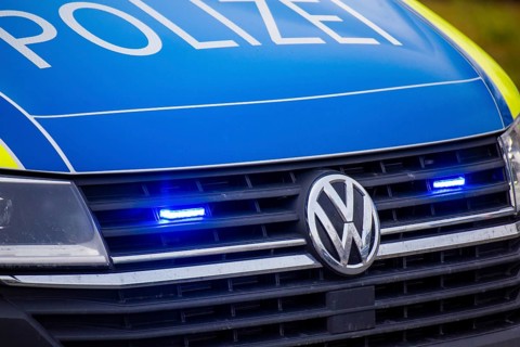 Police car with flashing blue lights in action