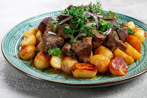 Kuyrdak, roast offal with potatoes and fresh herbs, homemade in Kazakh, no people