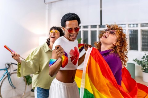 Happy multiracial and gender diverse lgbt people dancing an partying at home