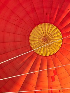 Hot air balloon inside view, top opens to release warm air before landing. Hot air balloon ride