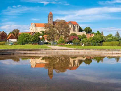 Castle hill with collegiate church of St. Servatius with reflection in water basin in autumn,