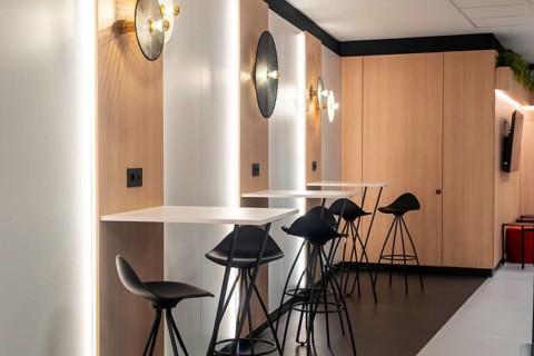 Modern airport workspace offering travelers a stylish area to work or relax, featuring sleek