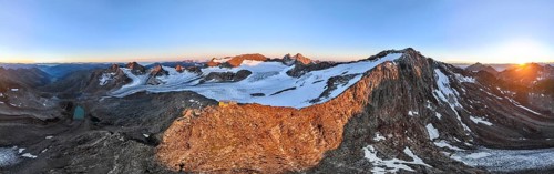 DefaultAtmospheric sunrise in a picturesque mountain landscape, alpenglow, aerial view, mountain