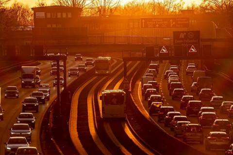 Motorway A40, dense, slow-moving traffic jam, evening traffic at the Essen-Kray junction, low sun,