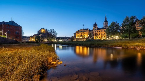 Town view with Upper Castle, Lower Castle and St Mary's Church on the River White Elster at dusk,