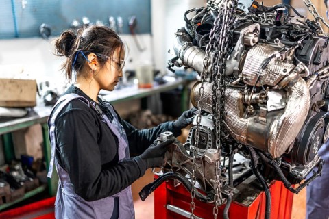 Skilled mechanic assembling engine parts in a professional workshop, showcasing expertise and