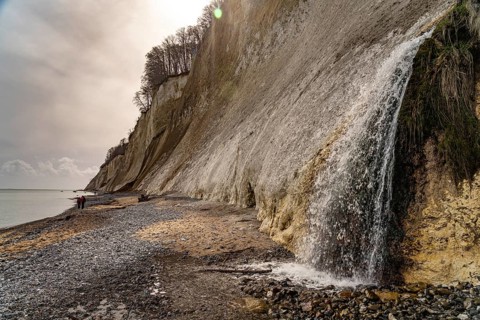 Waterfall of the Kiel stream on the Kiel shore and the famous chalk cliffs on the Baltic Sea coast