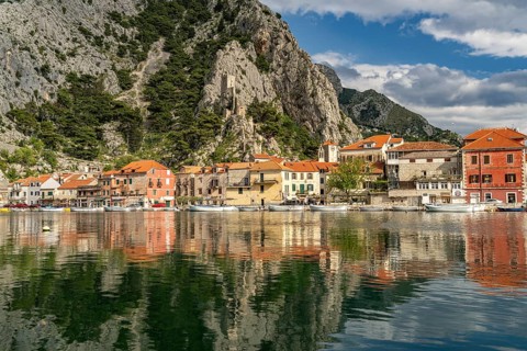 The old town centre of Omis on the river Cetina with the ruins of the Mirabella or Peovica