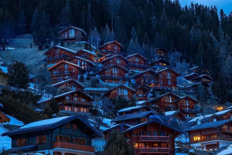 Chalets built into the hillside as holiday homes at dusk, Grimentz, Val d'Anniviers, Valais Alps,