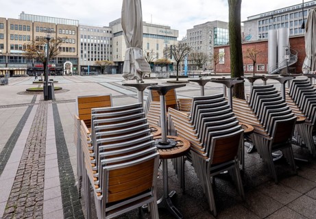 Deserted city centre with closed restaurants and shops due to corona pandemic contact ban,