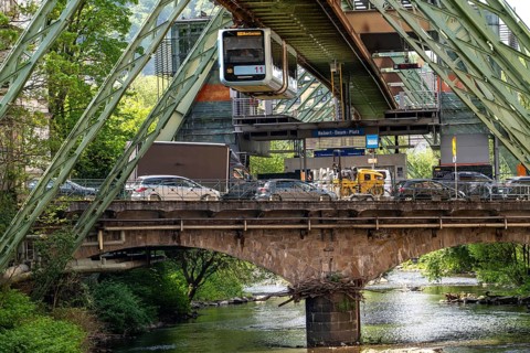 The Wuppertal suspension railway, train of the latest generation 15, floats above the Wupper,