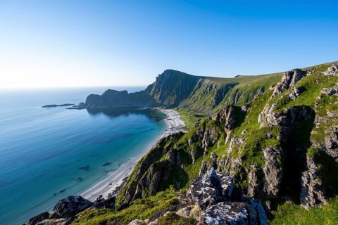 View of coastal landscape, cliffs with peak Måtind or Måtinden, Høyvika beach and sea, hike to the