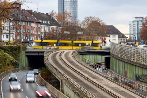 Motorway A40, Ruhrschnellweg, skyline of the city centre of Essen, exit Essen-Huttrop, track bus
