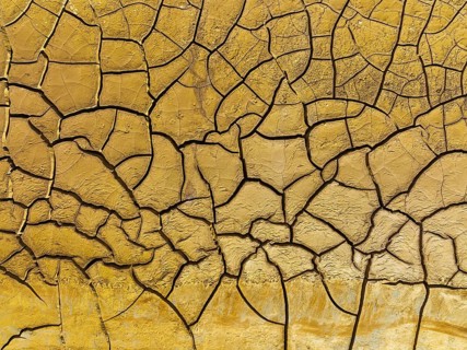 Mineral-rich cracked earth at the bank of the Rio Tinto (Red river), aerial view, drone shot,
