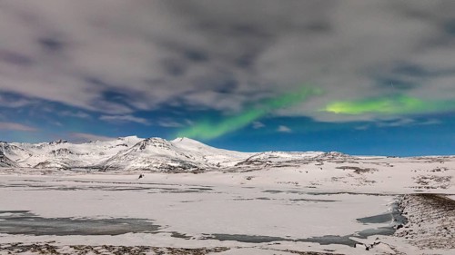 Northern Lights, Aurora Borealis, over snow-covered landscape at Skalafellsjökull, Sudurland,