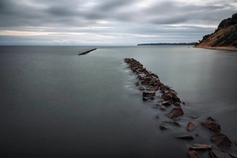 Coastal protection made of boulders, coastline on the Baltic Sea, dusk, long exposure, Baltic Sea