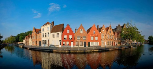 Typical Belgian cityscape Europe tourism concept, panorama of canal and old houses on sunset.