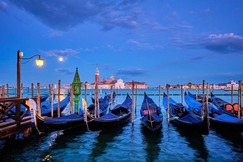 Romantic vacation Venice travel background, gondolas at Saint Mark (San Marco) square and Basilica
