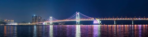 Panorama of Gwangan Bridge and skyscrapers illuminated in the night. Busan, South Korea, Asia