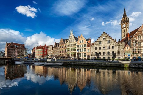 Europe Belgium medieval town travel background, Ghent canal and Graslei street on sunset. Ghent,