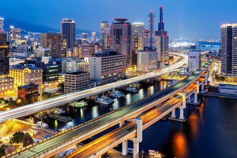 Kobe skyline from above with harbour and elevated roads at night in Kobe, Japan, Asia